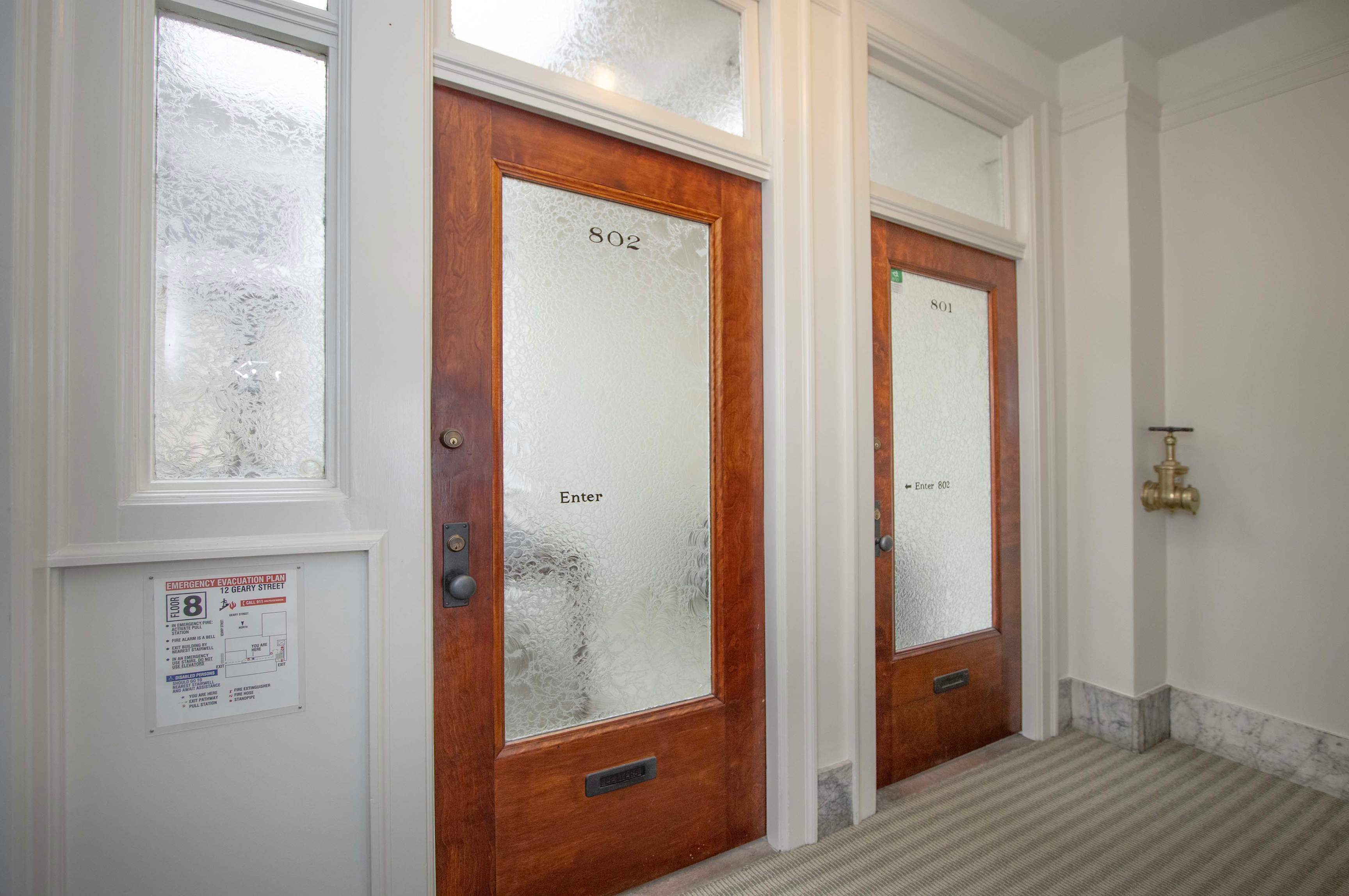 Historic wood and glass office suite doors at 12 Geary Street, suites 801 and 802