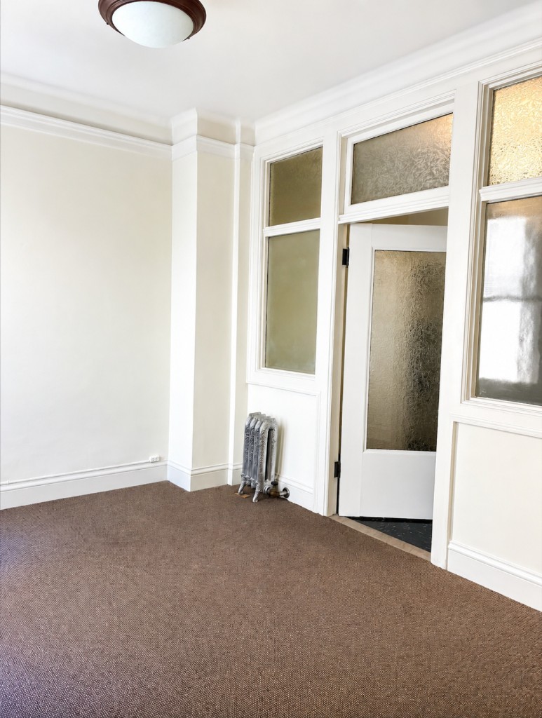 Suite 406–408 second office with frosted glass partitions and natural light