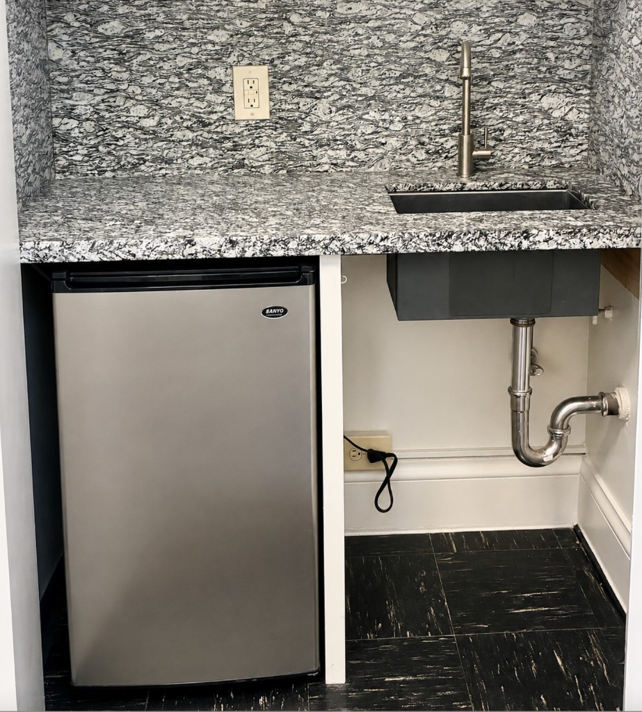 Suite 406–408 kitchenette with granite counter, sink, and mini fridge