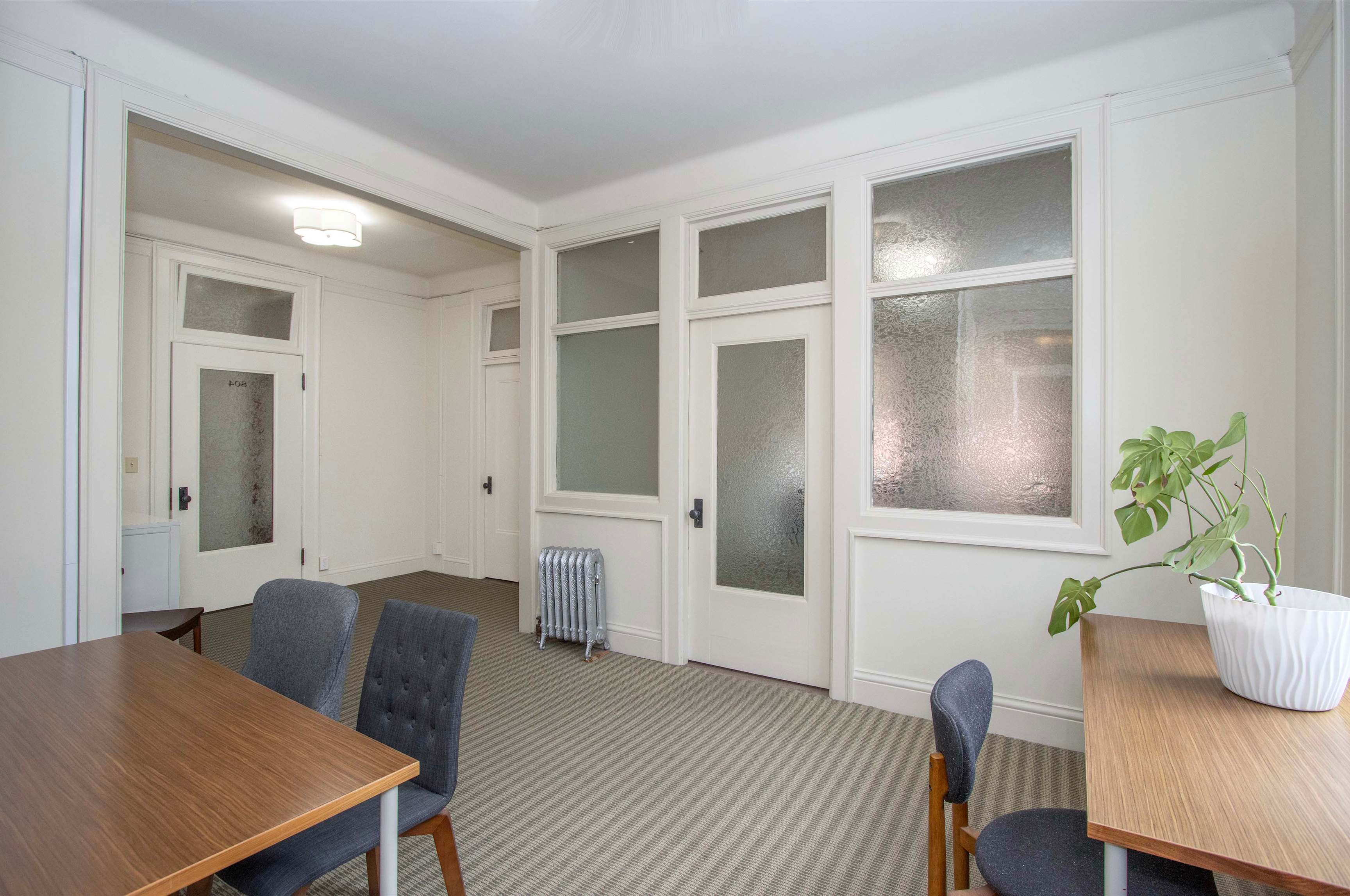 Suite 801–808 furnished team room with desks and chairs