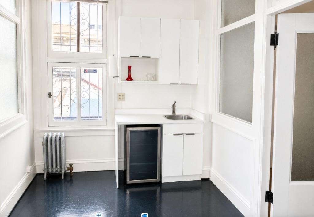 Suite 801–808 kitchenette with sink, cabinets, and beverage fridge